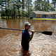 A man stands in front of his North Carolina home as floodwaters rise after Hurricane Florence